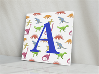 ABOUT:  Alphabet Letter A 8"x8" Square Dinosaurs in Background Blue or Pink Letter Canvas Wrap  Made to Order  CANVAS WRAP DETAILS  Mirrored image on four sides. Digital file used in the print process Canvas is cotton-poly has a white base with a satin finish. Image printed with latex ink. Canvas is hand-stretched on notched 1.5-inch wood stretcher bars. The wrap is secured to the stretcher bars using staples. The back is covered with brown kraft paper, glued, and taped in place.