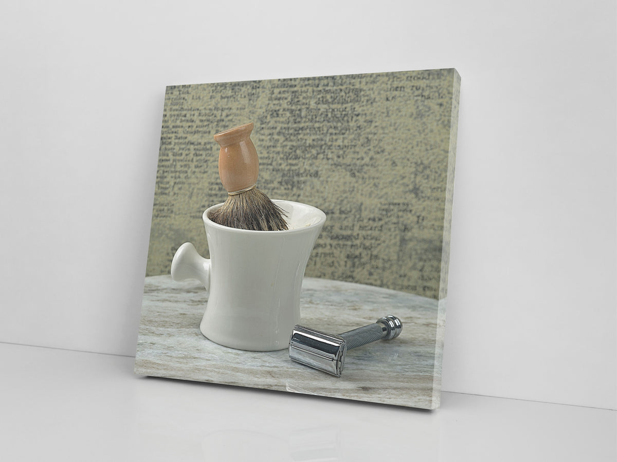 A shaving mug and brush product image printed on 20x20 inch canvas wrapped on artist&#39;s stretcher bars. The cotton-poly canvas has a semi-gloss finish and is hand-stretched and stapled in place. Kraft paper covers the back of the frame.
